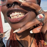 a woman with dreadlocks and a ring on her finger