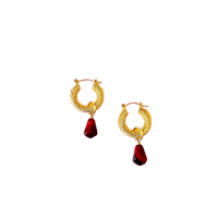 a pair of gold hoop earrings with red stones